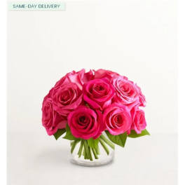 Pink roses arranged in a clear glass vase