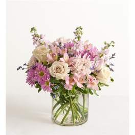 Bouquet of pink and cream flowers in a clear glass vase