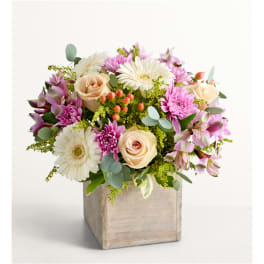 Pink and cream mixed flowers in a wooden cube vase
