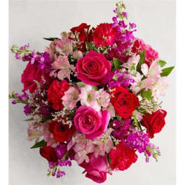 Round bouquet of red, pink, and purple flowers