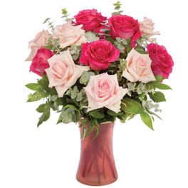 Pink and pale blush roses arranged in a glass vase