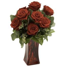 Red roses arranged in a red glass vase