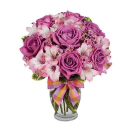 Pink and purple roses with white alstroemeria in a glass vase