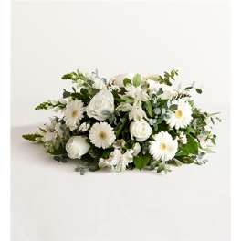 White floral arrangement with roses and daisy-like blooms