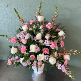 Pink and white floral arrangement in a white vase
