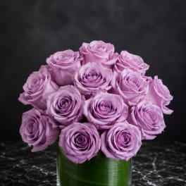 Lavender rose bouquet in a clear glass vase