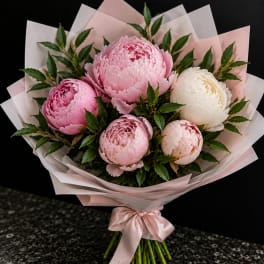 Pink and white peony bouquet wrapped in pale pink paper