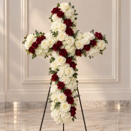 Cross-shaped floral standing spray with white roses and red carnations