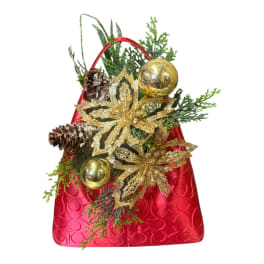 Christmas gift bag with pinecones, gold ornaments, and glittery poinsettias
