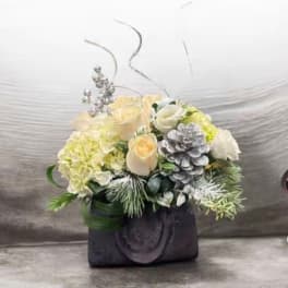 Cream roses and hydrangea in a black vase with silver accents