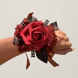 Red rose wrist corsage with ribbon and rhinestone accents