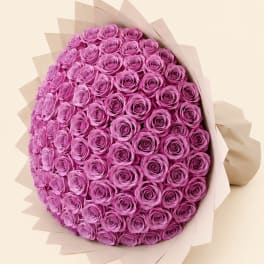 Large bouquet of pink roses wrapped in pale paper