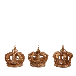 Three gold decorative crown ornaments on a white background
