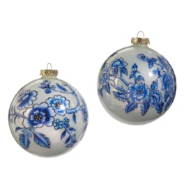 Two blue floral Christmas ornaments on a white background
