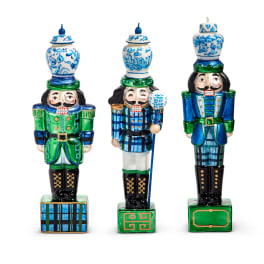 Three decorative nutcracker figurines with blue and green painted details