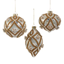 Three ornate gold and white hanging Christmas ornaments on a white background
