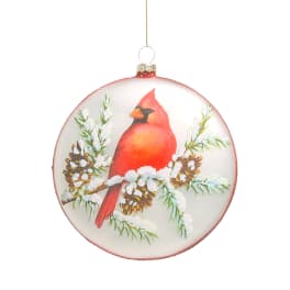 Round hanging ornament with a red cardinal and pinecones