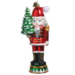 Santa ornament holding a snow-dusted Christmas tree