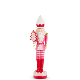 Pink and red nutcracker figurine holding a Christmas tree
