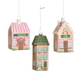 Three hanging house ornaments with pastel storefront designs