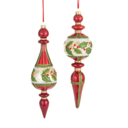 Two red Christmas ornaments with holly designs hang on white background