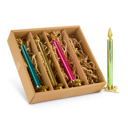 Box of metallic candles with gold holders and one standing beside it