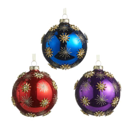 Three decorated Christmas ornaments in blue, red, and purple