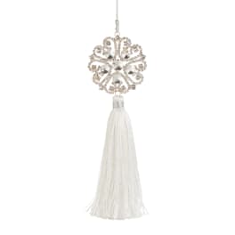 Decorative silver ornament with a white tassel hanging on a cord