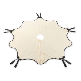 Cream-colored decorative fabric cover with black ribbon ties