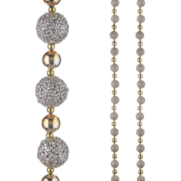 Sparkling beaded garland with silver and gold spheres on a white background