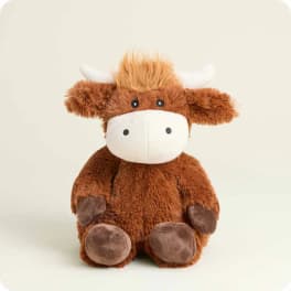 Brown plush cow toy with white face and horns