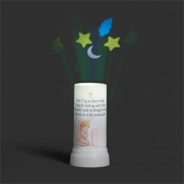 White memorial candle with a praying child illustration and star projections
