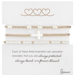 Three beaded bracelets on a white card with heart and cross charms