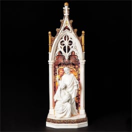 White religious figurine in a gothic arch frame on a black background
