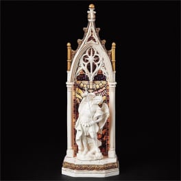 Decorative religious statue in a Gothic-style frame with an angel figure