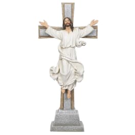 Religious statue of Jesus on a cross with outstretched arms