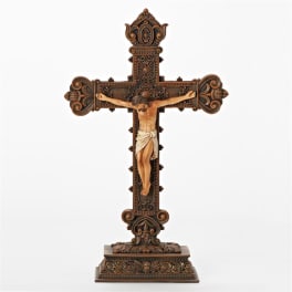 Ornate crucifix statue on a decorative base