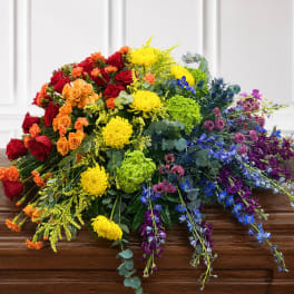 Colorful casket spray with roses, mums, and delphinium