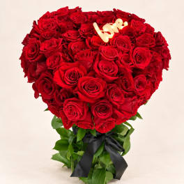 Heart-shaped bouquet of red roses with a black ribbon