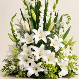 White lilies and tall white spikes in a low floral arrangement