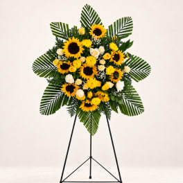 Standing floral spray with sunflowers and white roses on a tripod easel