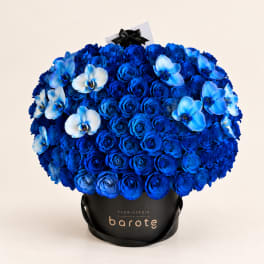 Blue rose bouquet with light blue orchids in a black hatbox