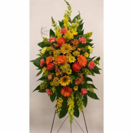 Tall standing floral spray with yellow, orange, and pink flowers