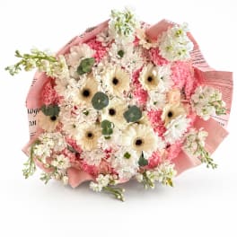 Pink and white mixed bouquet with gerbera daisies and carnations wrapped in pink paper