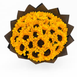 Bouquet of yellow sunflowers wrapped in dark paper