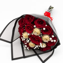 Bouquet of red and cream roses wrapped in black mesh with a red ribbon
