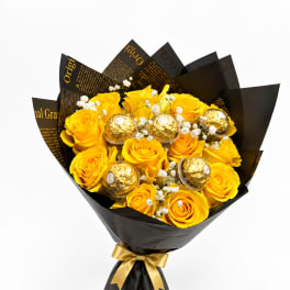 Yellow rose bouquet with gold-wrapped chocolates in black paper