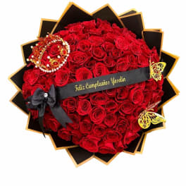 Heart-shaped bouquet of red roses with black and gold wrapping