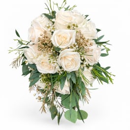 White rose bouquet with green foliage and small gold accents
