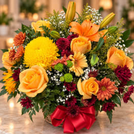 Basket arrangement of yellow and orange roses with mixed chrysanthemums and lilies